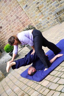 Stretching Woman Helps Man